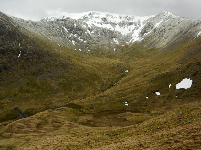 The breach in the moraine wall at Keppel Cove, with the remains of the 1928 concrete dam, and Brown Cove and a snow-covered Helvellyn behind.
