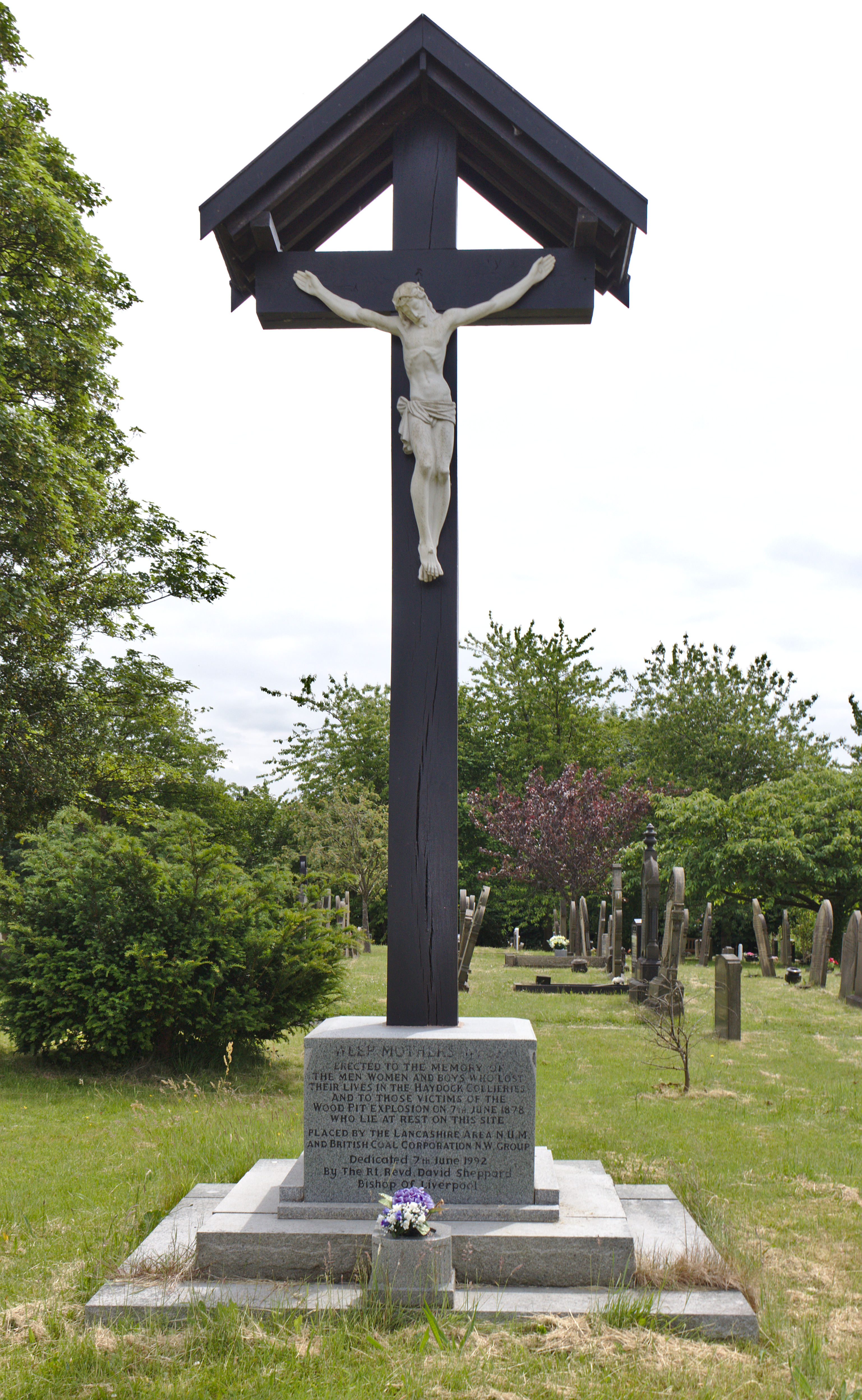 A calvary memorial in the churchyard of St James the Great church, Haydock, dedicated to the victims of local mining disasters, especially the 1878 Wood Pit explosion.