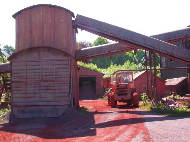 Bright red haematite iron ore staining the ground at Florence Mine, Egremont, Cumbria.