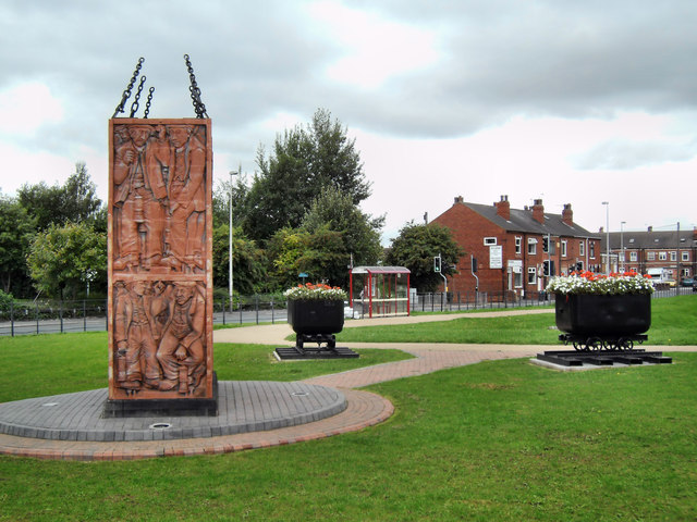 A stone memorial to Allerton Bywater Colliery standing in the village.
