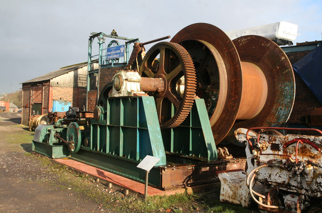 A preserved compressed-air mine winch on display outdoors at Apedale Heritage Centre, the former colliery site now open to visitors.
