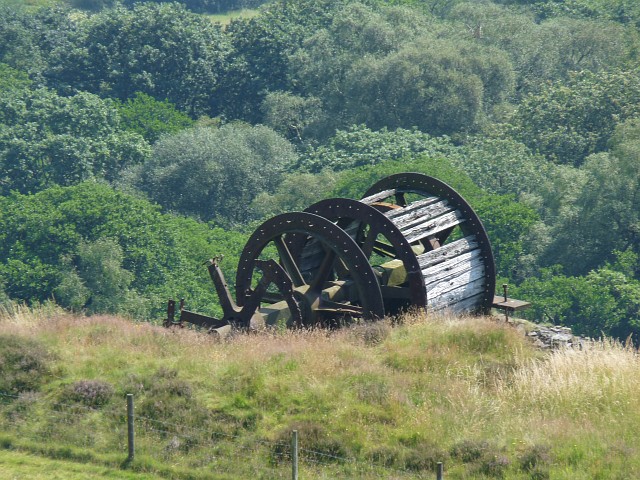 A colliery winding wheel mounted as a memorial at Bedwellty Pits, south of Tredegar.