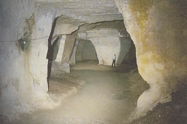 The chapel carved within Beer Quarry Caves, said to have sheltered a secret Catholic congregation after the Reformation.