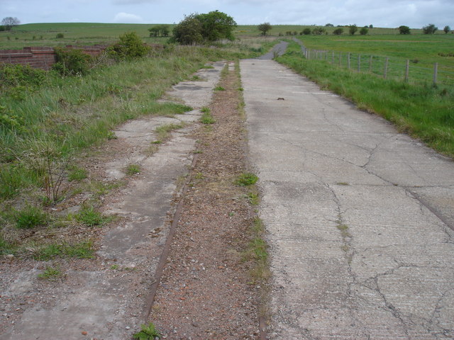 Narrow-gauge rails running down a concrete ramp at the site of Blackburn Fell Drift.