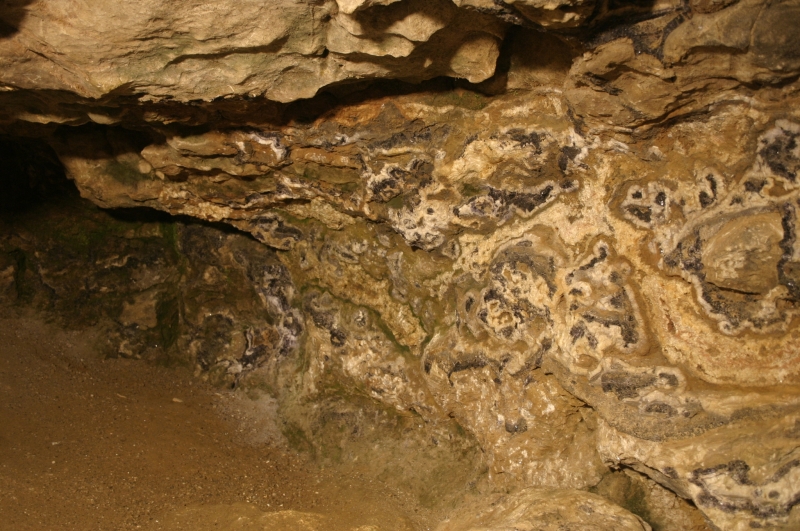 Bands of purple-blue and yellow Blue John fluorspar exposed in the rock wall of Blue John Cavern, Castleton.