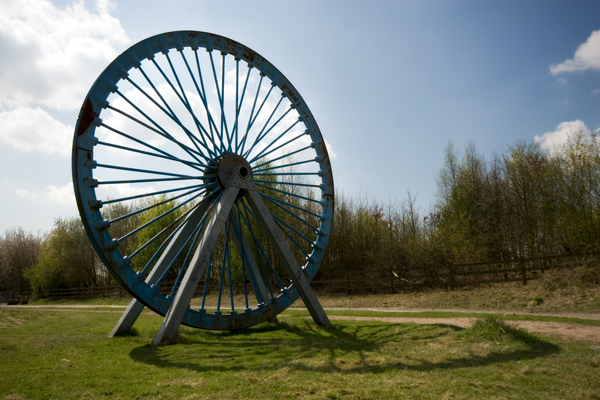 A preserved winding wheel, painted blue, marking the site of Bold Colliery, St Helens.