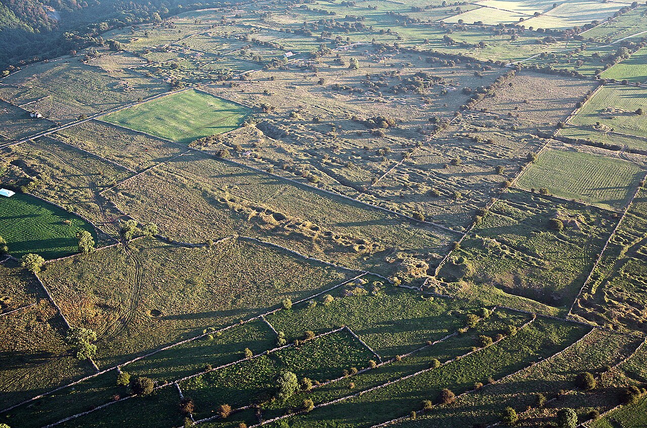 Long, narrow lead rake earthworks running across open moorland at Bonsall Moor, part of the scheduled Bonsall Leys lead-mining monument.