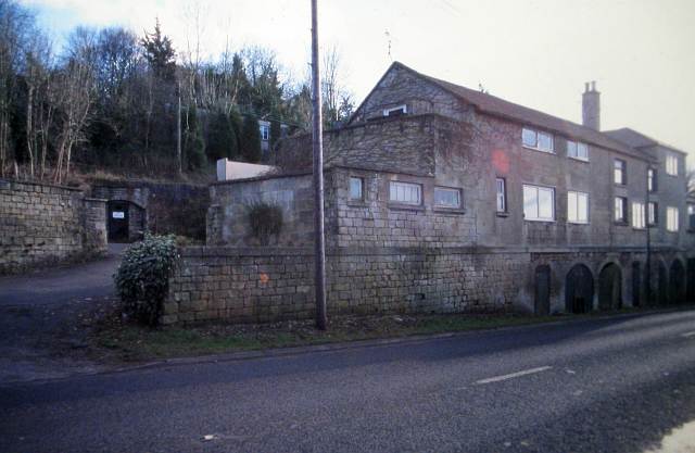 The archway entrance to Clift Quarry, part of the wider Box Quarry system, beside the former offices of Bath Stone Firms, now converted to housing.