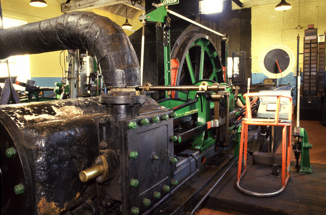 A small horizontal steam winding engine in its engine house at a colliery.