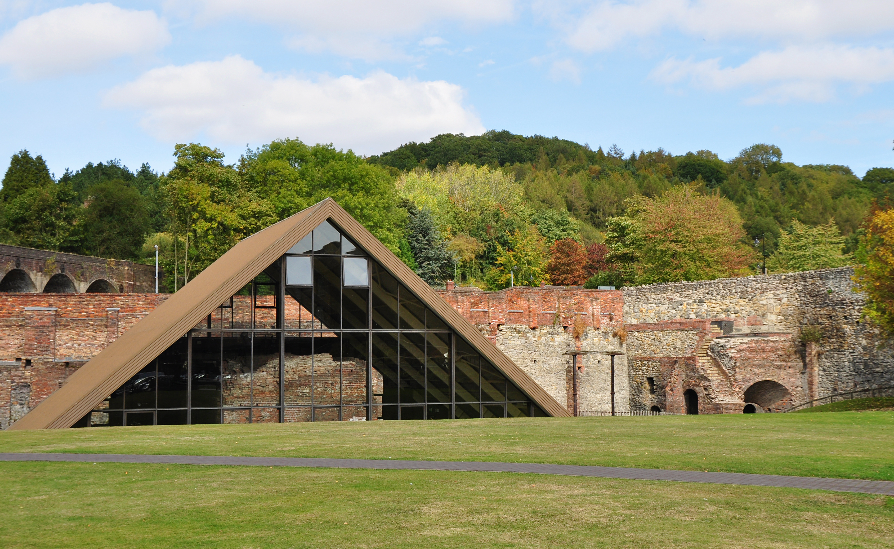 Abraham Darby's Old Furnace at Coalbrookdale, the brick tower structure where iron was first successfully smelted with coke in 1709, preserved in situ beneath a protective roof.