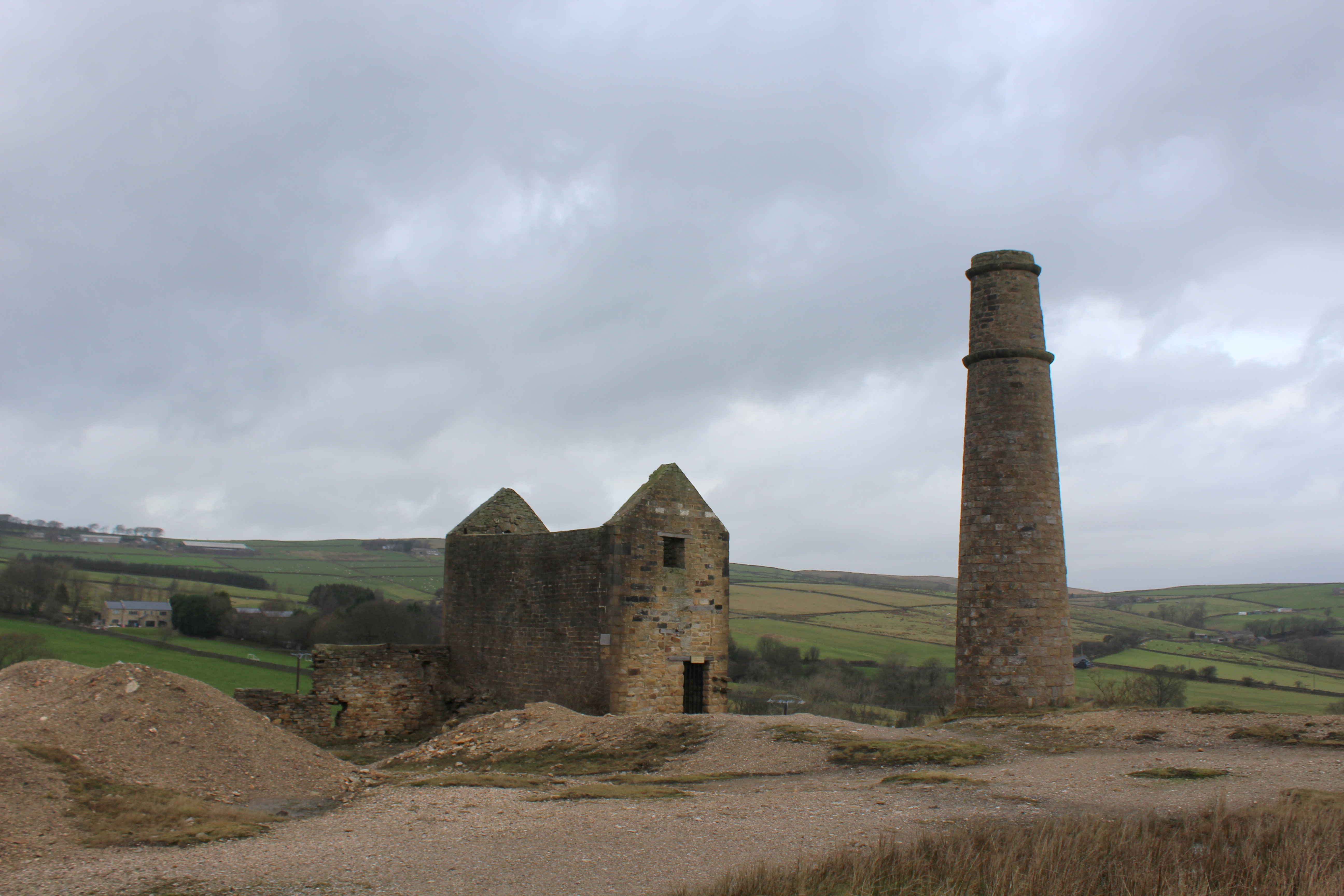 The roofless stone engine house and chimney of the former Cononley lead mine in North Yorkshire.