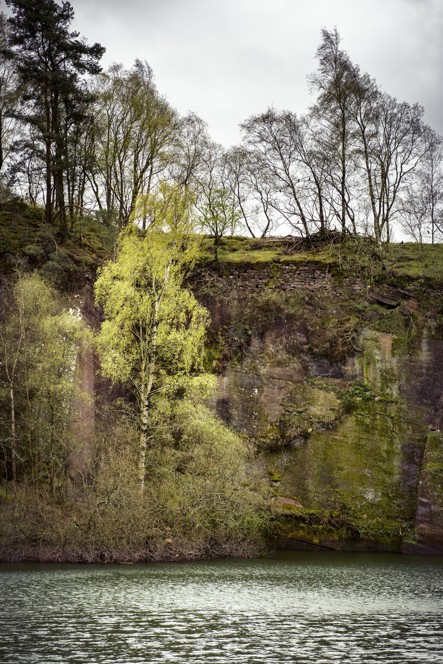 Working faces of red Permian sandstone at Corncockle Quarry near Templand in Dumfries and Galloway, showing the bedded stone worked in benches
