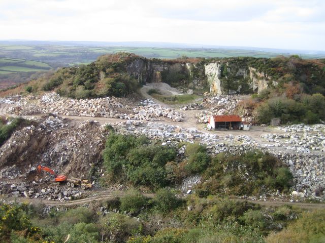 The granite working faces at De Lank Quarries near Hantergantick on the western edge of Bodmin Moor, with cut blocks and quarry plant below the rock face
