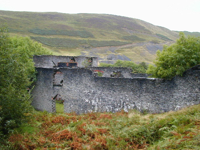 The ruined Belgian-built hydroelectric power station at Frongoch, with the mine workings visible on the hillside behind.