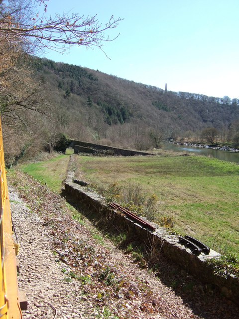 The distinctively leaning arsenic-flue chimney at Gawton Mine, visible in the distance above old workings on the Devon bank of the River Tamar.