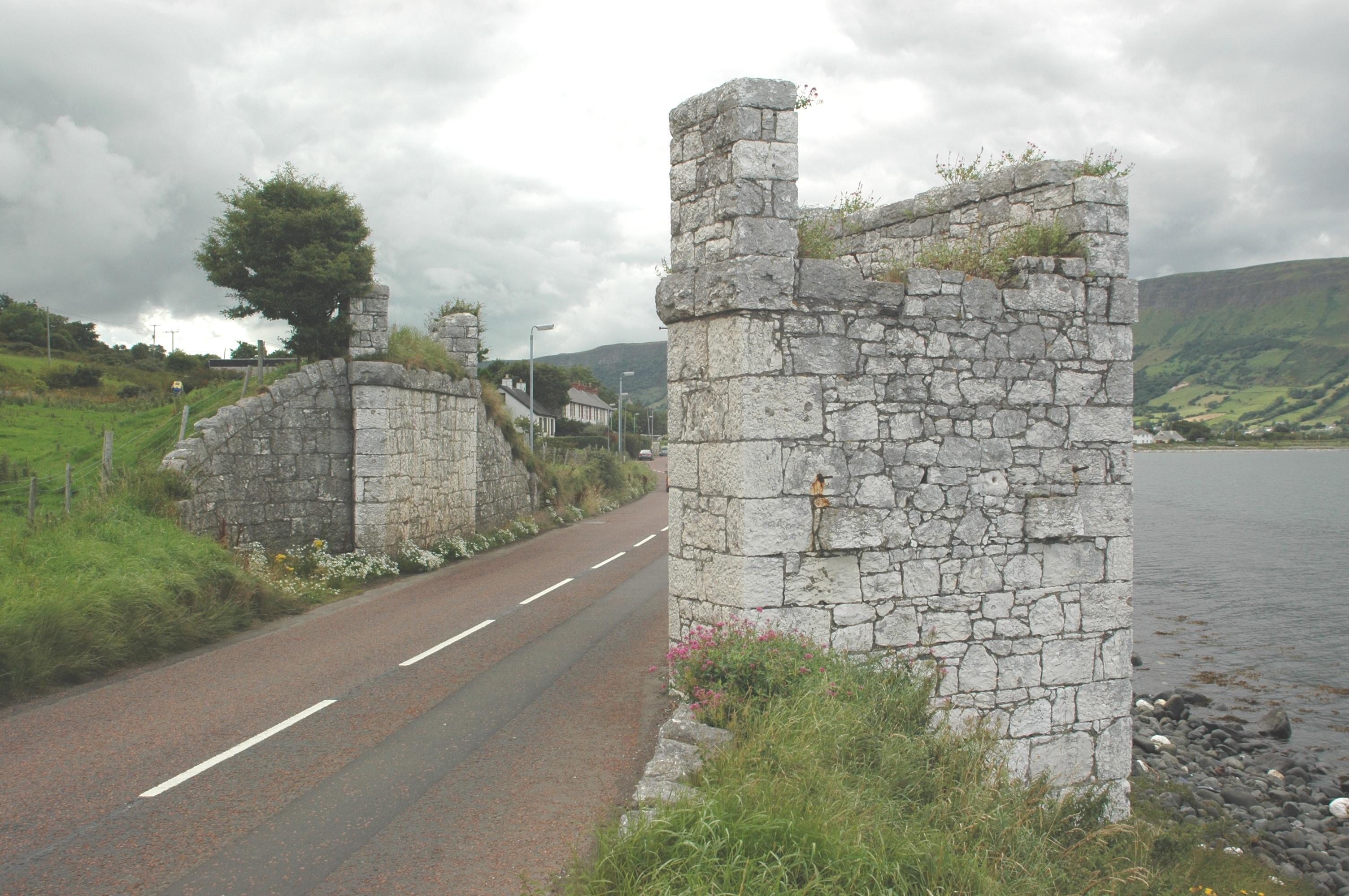 The surviving limestone piers of the White Arch, which once carried the Glenariff Iron Ore and Harbour Company's narrow-gauge railway across the Antrim Coast Road at Waterfoot.