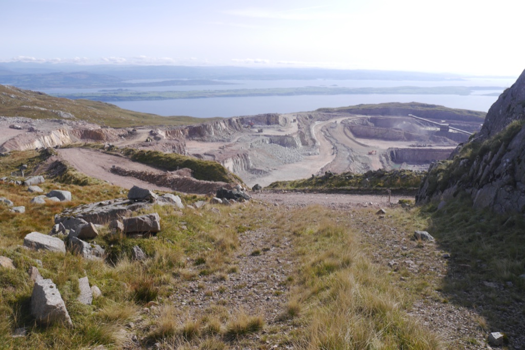 The granite workings at Glensanda cut into the hillside of Meall na h-Easaiche above Loch Linnhe, with quarry benches and plant visible on the bare rock face