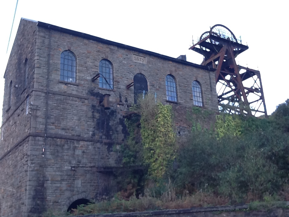 The stone winding engine house and steel headframe of the Hetty Pit at Hopkinstown near Pontypridd, the sole surviving structures of the Great Western Colliery