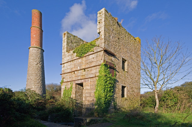 The ruined granite 60-inch pumping engine house on Leeds shaft at Great Work Mine, seen from outside, with its distinctive tall bob wall and round-arched plug doorway.