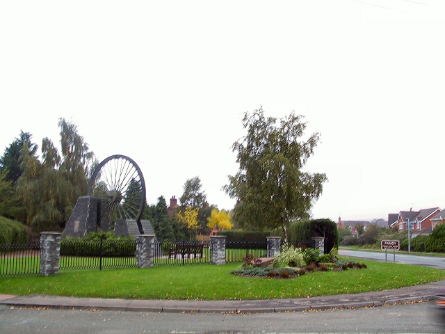 The Gresford Memorial at Pandy — a pithead winding wheel mounted as a monument, unveiled by the Prince of Wales in 1982 to commemorate the 266 miners killed in the 1934 disaster.
