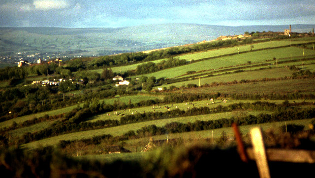 View east across grazing land from Kit Hill showing the buildings of former Hingston Down Consols mine and the slopes of Hingston Down Quarry