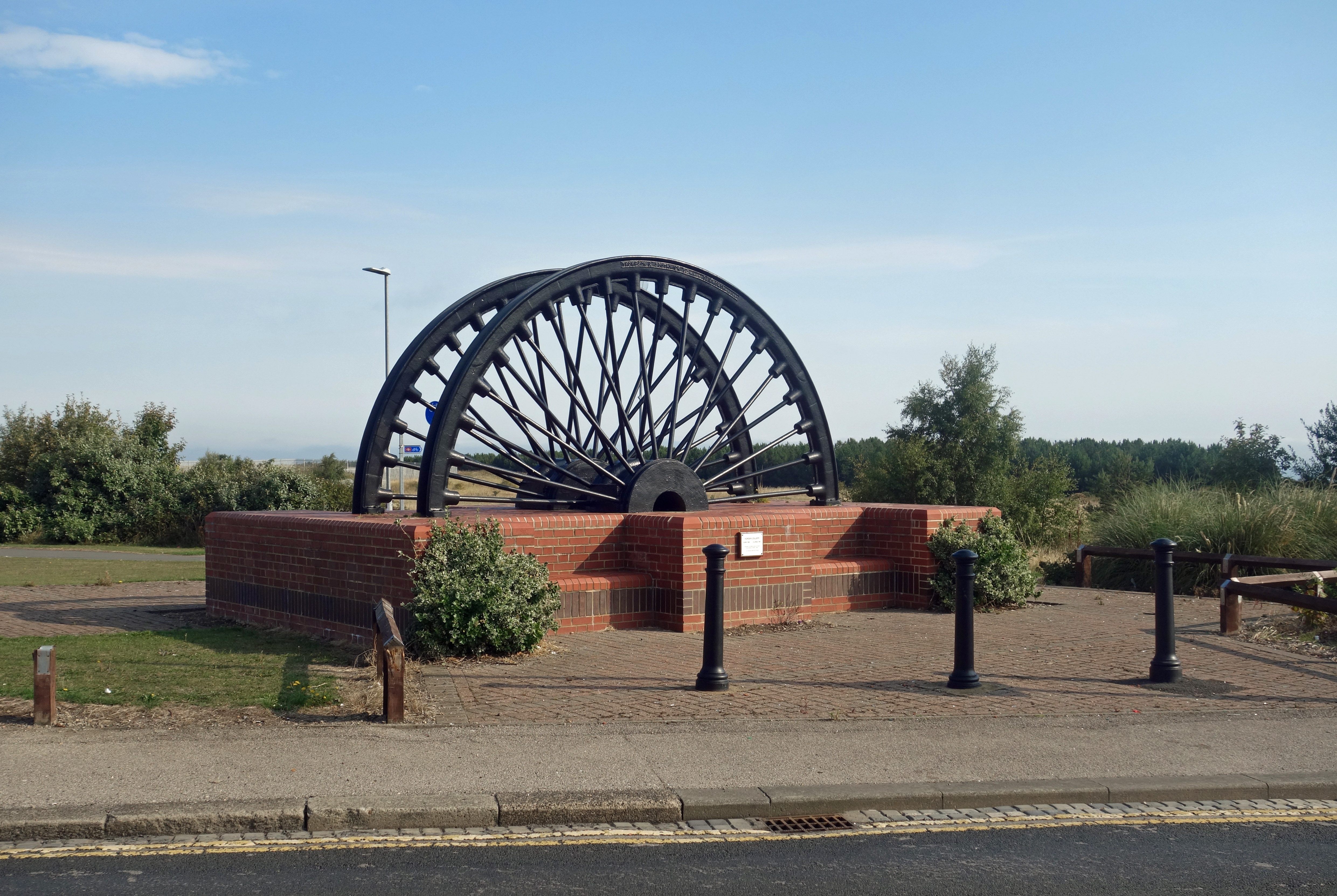 The Horden Colliery memorial, made from the colliery's own pit head winding wheels, standing on the former colliery site.
