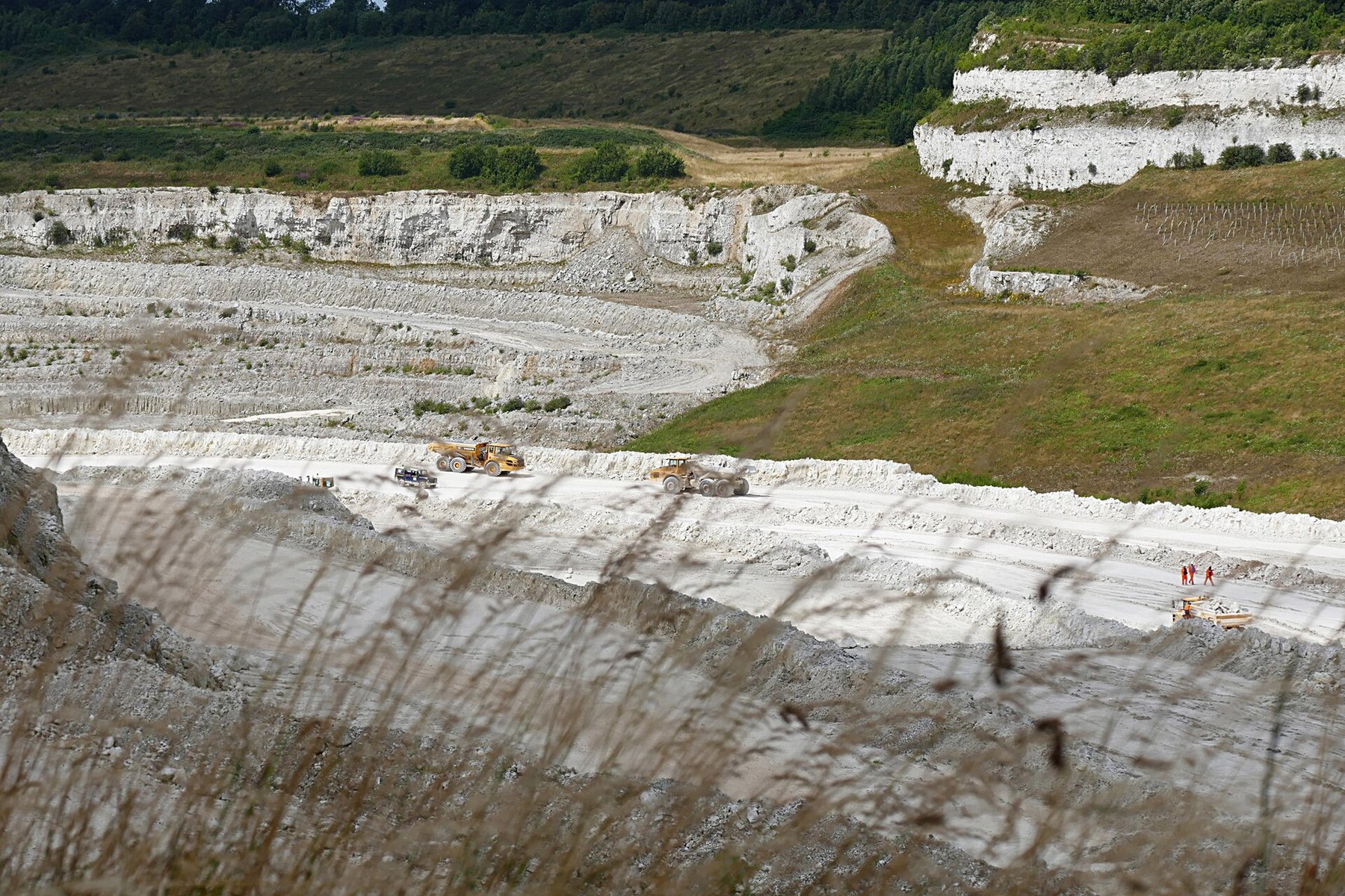 The working white chalk faces and benches of Kensworth Quarry near Dunstable in Bedfordshire, the largest active chalk quarry in the United Kingdom