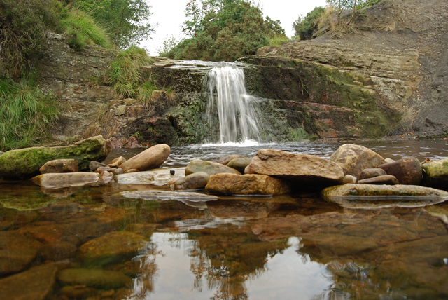 A small waterfall dropping over a rock ledge near the bottom of Lead Mines Clough on Anglezarke Moor.