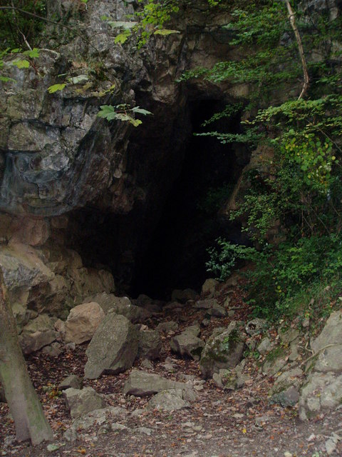 A dark cave entrance in a limestone cliff face at Loggerheads, one of the old mine shaft entrances exploited by 18th- and 19th-century lead miners.