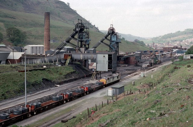 A steel coil bound for the Ebbw Vale tinplate works is hauled past Marine Colliery shortly after its March 1989 closure, with colliery headgear visible.