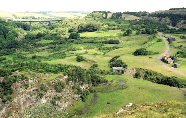 The disused quarry face at Meldon, with vegetation reclaiming part of the former workings.