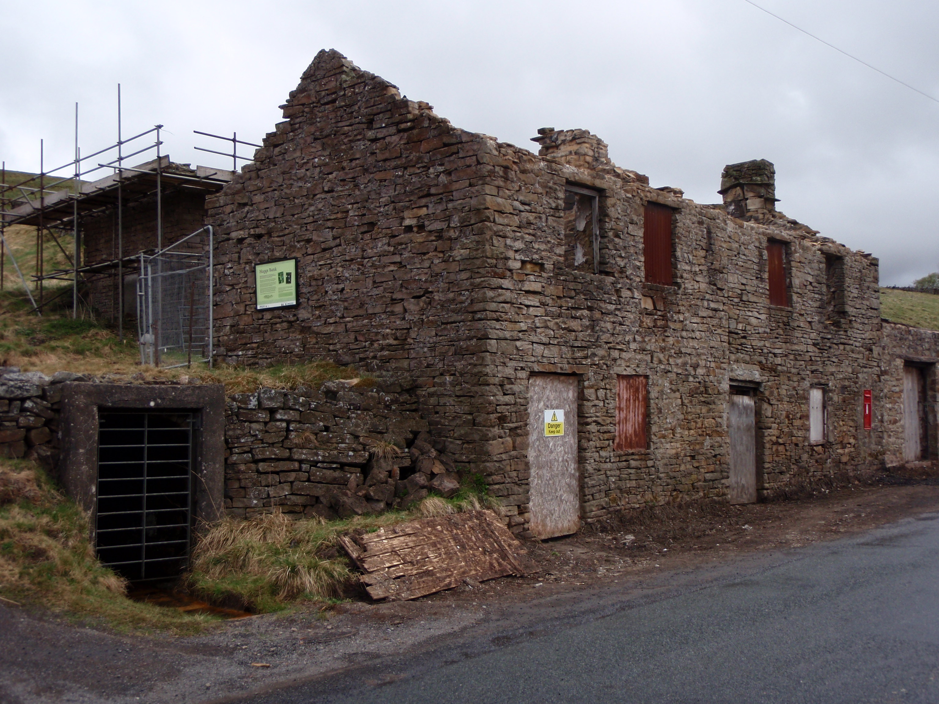 The gated stone portal and adjacent former mine shop building at Nentsberry Haggs Mine, Alston Moor