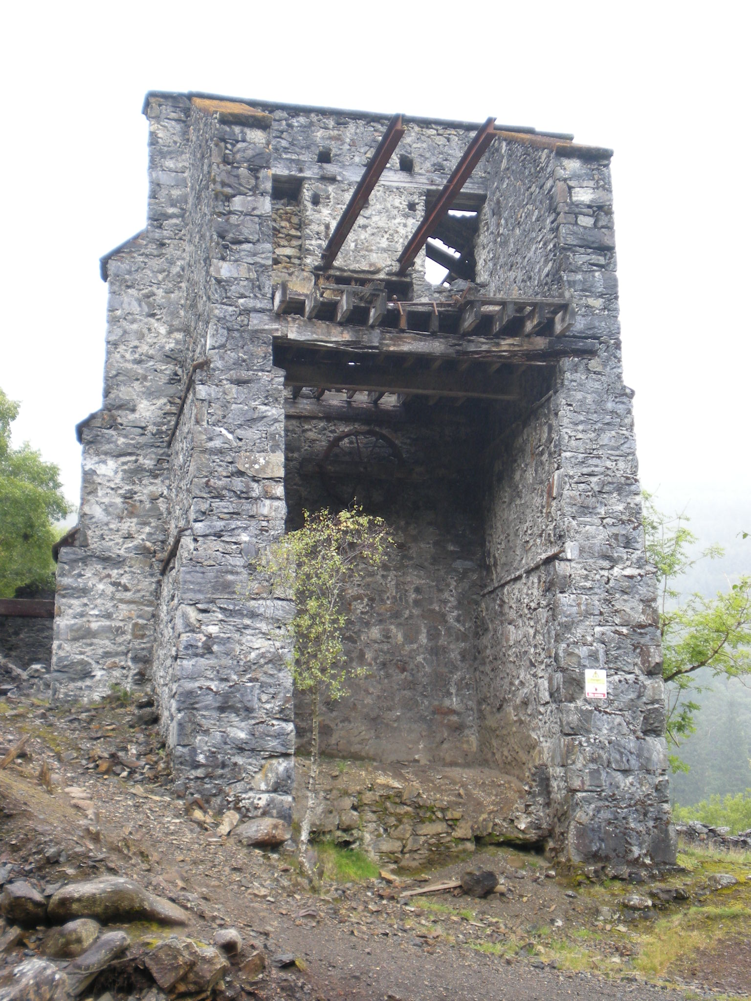 The ruined Klondyke processing mill, viewed from the mine entrance over the stream, near Trefriw, north Wales.