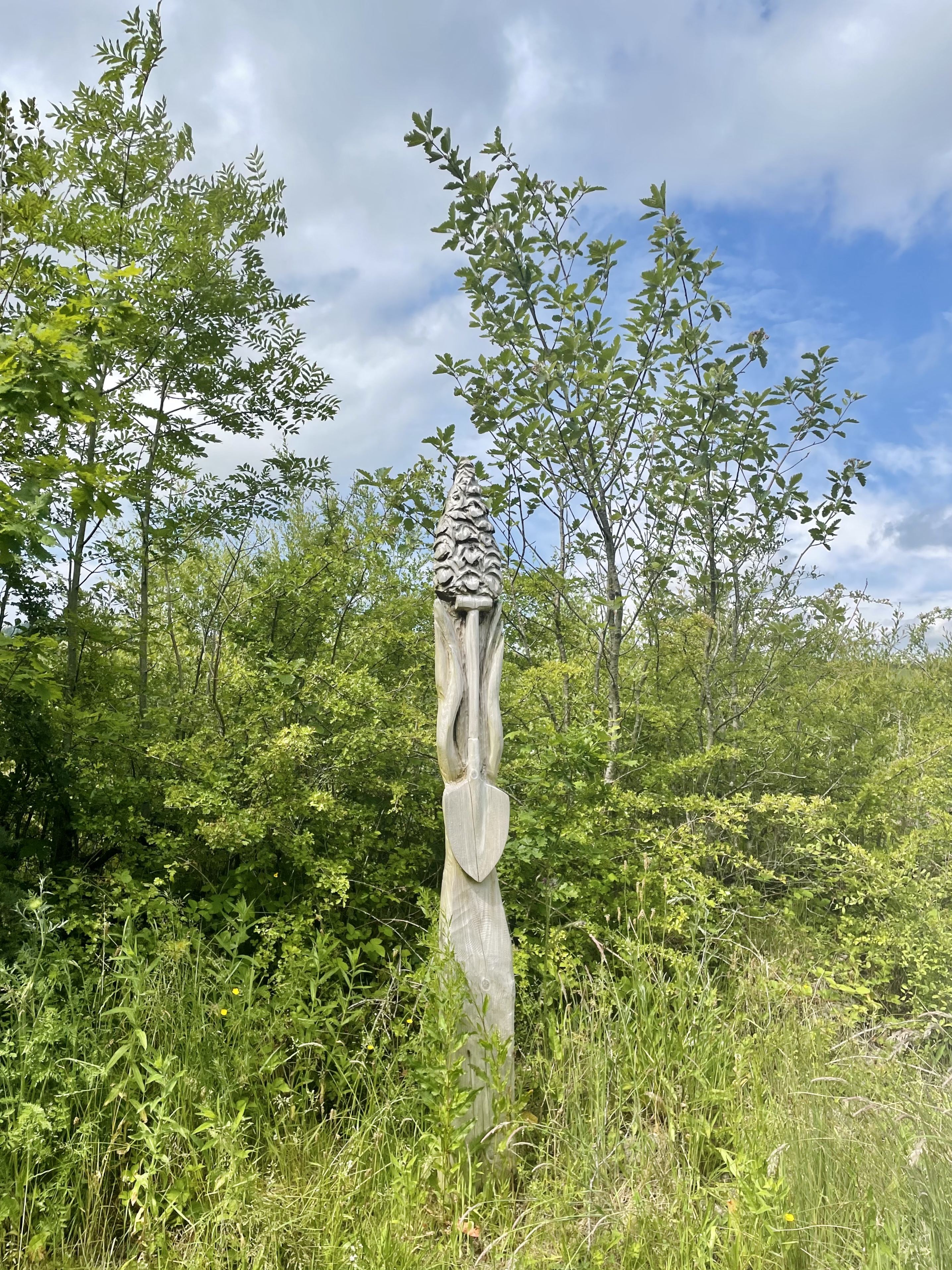 A wooden statue commemorating the colliery's mining heritage at Parc Slip Nature Reserve, on the site of the former Park Slip Colliery.