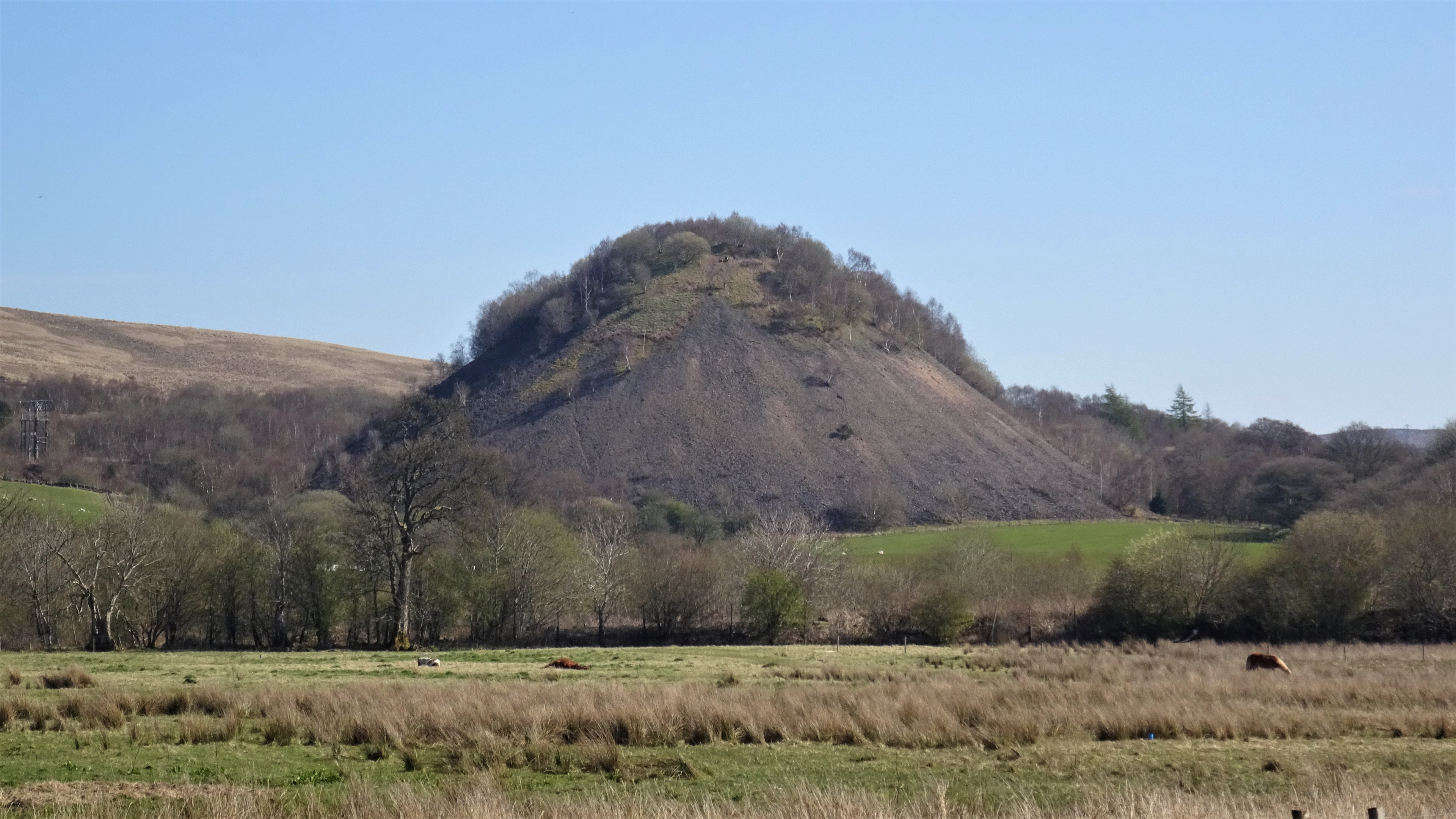 The spoil bing of Pennyvenie Colliery on the hillside above Dalmellington, East Ayrshire, photographed in April 2023.