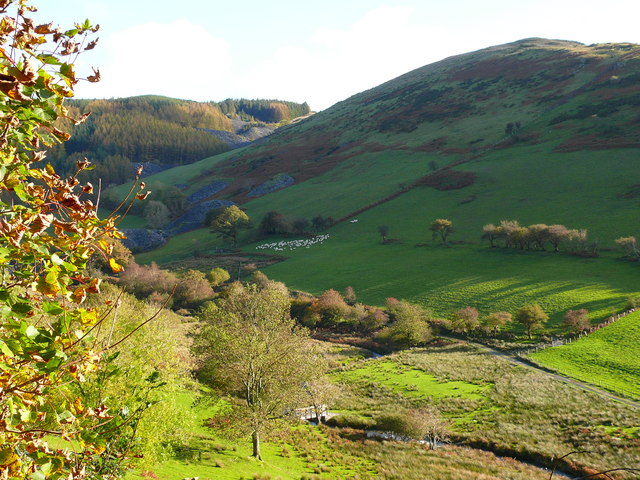 Cwm Ratgoed, with old quarry workings visible on the hillside behind the footbridge over the Nant Ceiswyn.