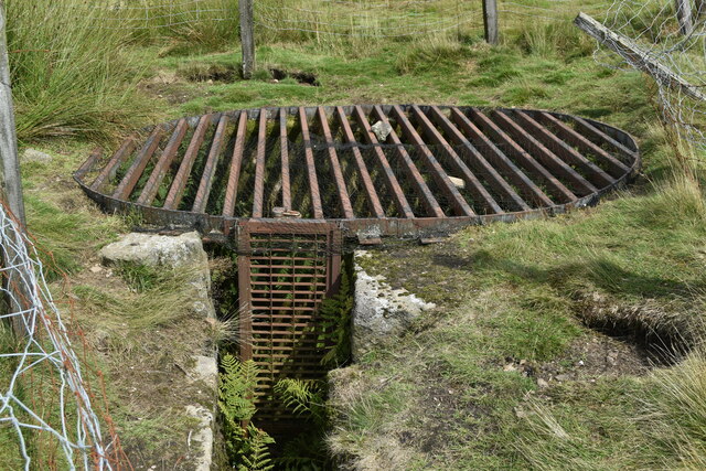 A caged mine shaft opening at the former Red Scar Lead Mine near Grimwith Reservoir, North Yorkshire