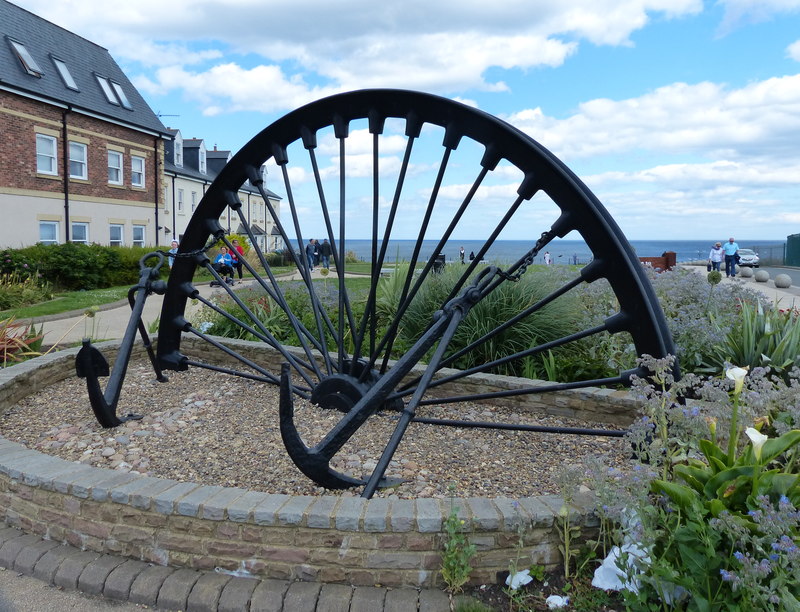 A colliery winding wheel mounted as a memorial at Seaham, County Durham.