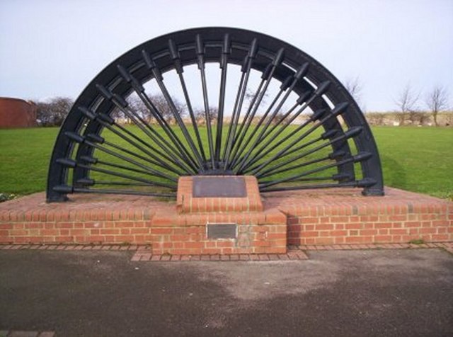 A colliery pit wheel set up as a memorial in Shotton Colliery village, inscribed with the names of miners killed at the pit.