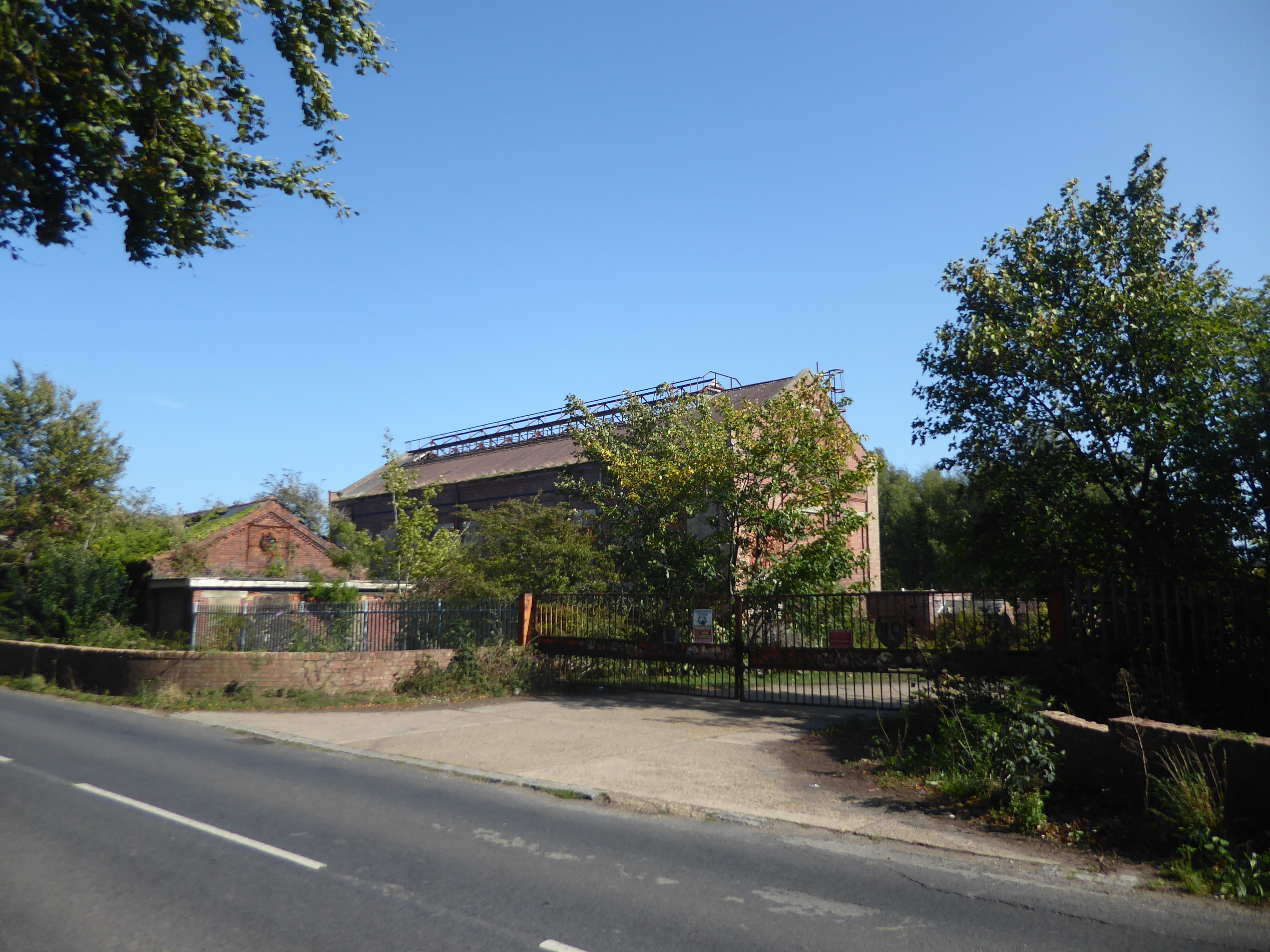 Derelict colliery buildings and overgrown ground at the former Snowdown Colliery, Kent.