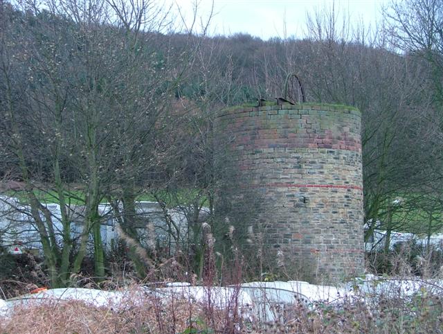 A squat stone ventilation shaft standing in grass at Margrove Park, one of the few surviving remains of the Stanghow ironstone mine.