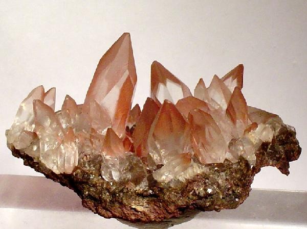 Cluster of red-tinted calcite crystals with haematite from Stank Mine.