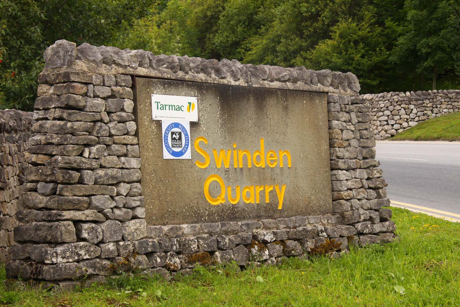 The entrance to Swinden Quarry near Cracoe in Wharfedale, with the working limestone quarry and its plant beyond