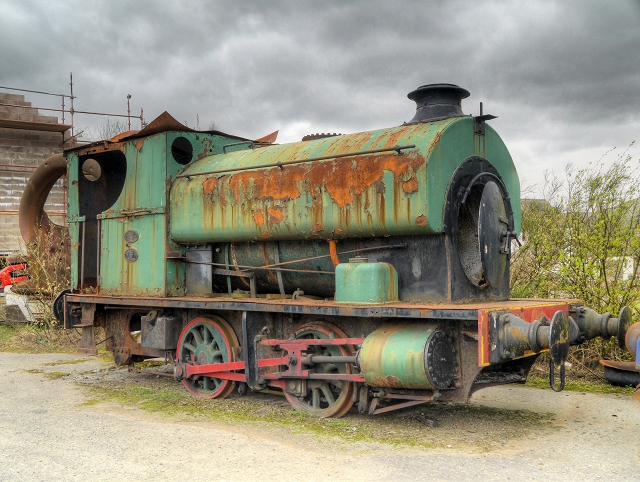 A rusting locomotive among the preserved industrial machinery at Threlkeld Quarry and Mining Museum.