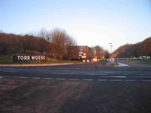 The entrance to Torr Works limestone quarry at East Cranmore on the Mendip Hills, with the site signage and landscaped screening