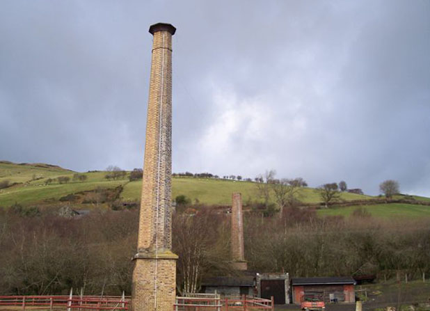 The two surviving chimneys at Van Mine, one visibly leaning.