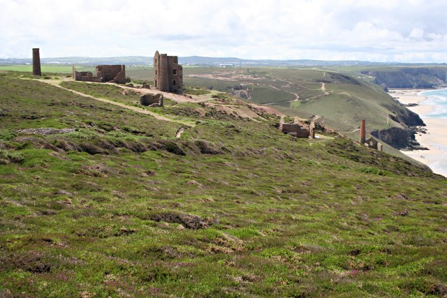 A stone-arched adit entrance in the cliffside at Wheal Coates, Cornwall.
