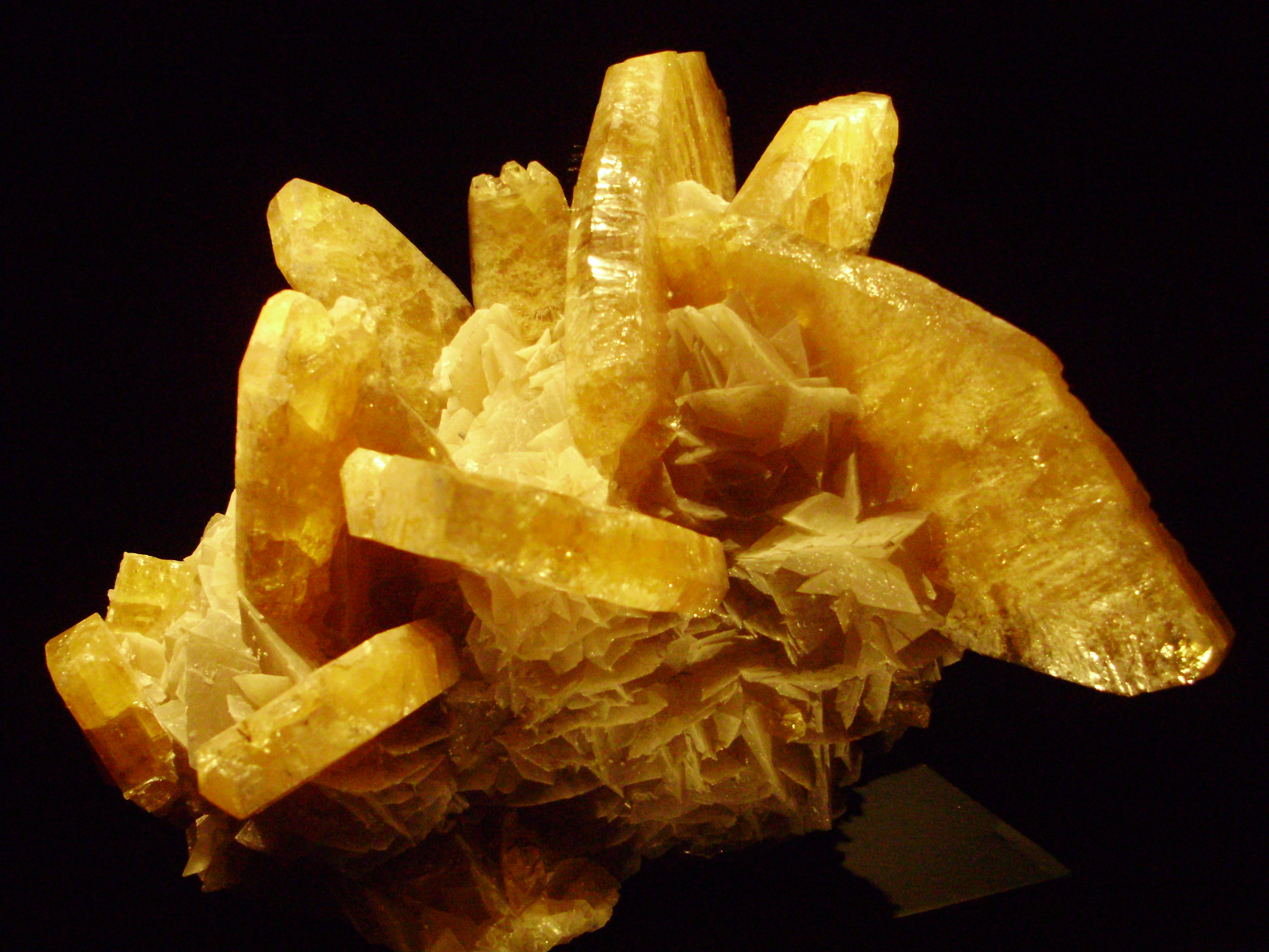 A cluster of tabular barite (barium sulphate) crystals, the dense mineral recovered as a by-product of lead mining and, later, worked for its own value as a drilling-mud additive.