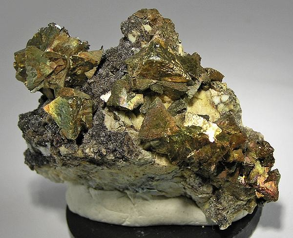 A brass-yellow cluster of chalcopyrite crystals, the principal copper ore mineral worked across Cornwall and Devon.