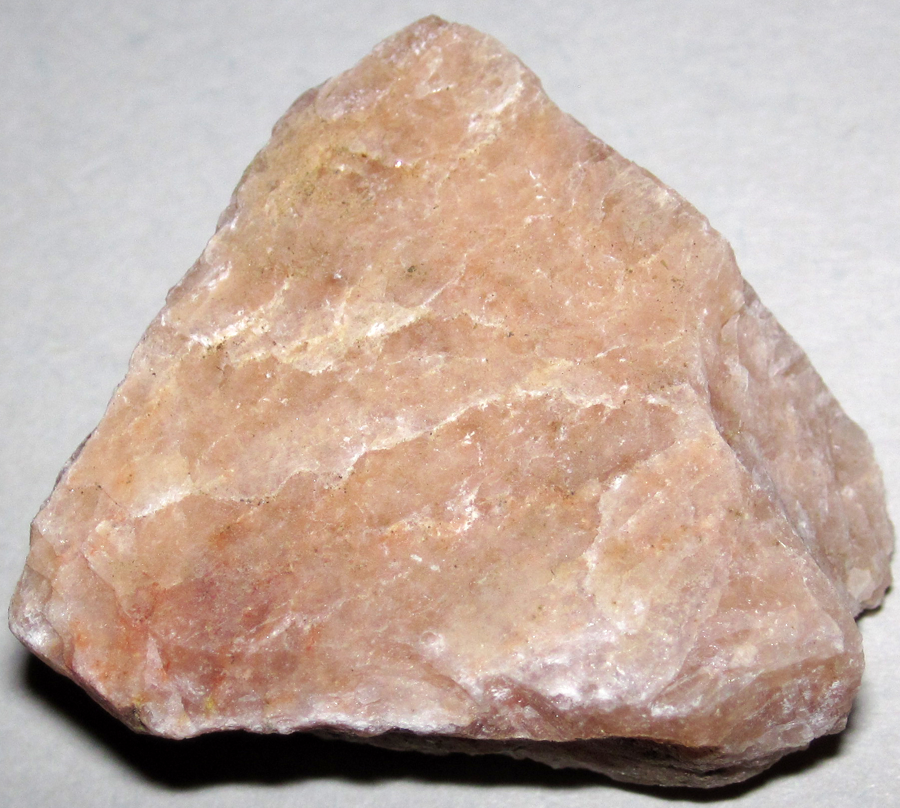 A whitish-pink specimen of potassium feldspar, the flux mineral used in porcelain and glass manufacture.